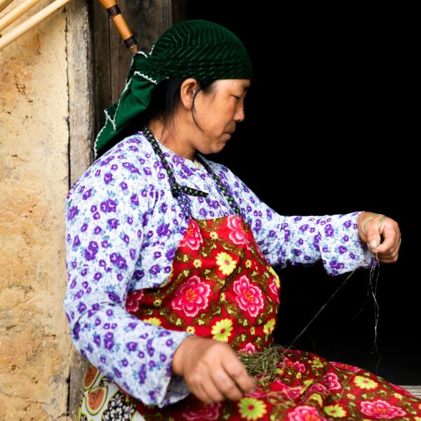 A woman is sitting on a chair with a basket